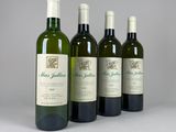 four bottles of wine are lined up on a table