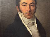 portrait of a man in a black coat and white shirt