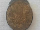 a brown object on a white cloth with a red string