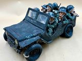 a group of soldiers riding in the back of a toy truck