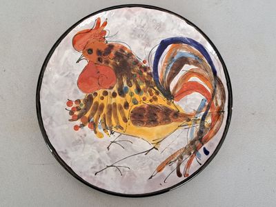 a plate with a painting of a rooster on it