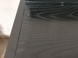 a black wooden desk with a drawer on top of it