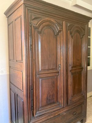 an image of a large wooden armoire in a living room