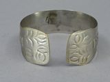 silver cuff bracelet with engraved design on the outside of the cuff