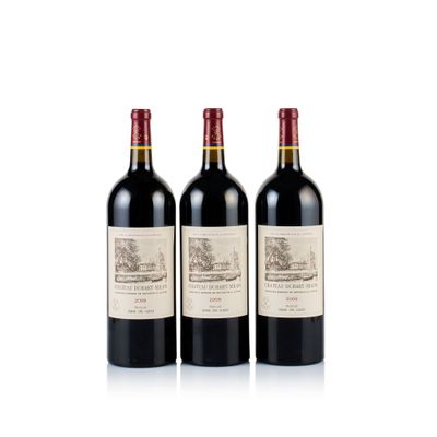 three bottles of red wine sitting next to each other on a white surface