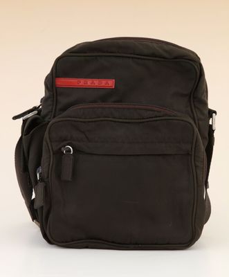 the back of a black backpack with a red label on it