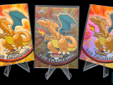 three pokemon cards are on display in a row on a black background