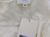 a close up of a white shirt with a tag on it