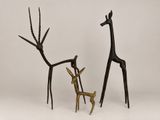 bronze sculpture of a deer and a giraffe standing next to each other