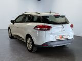 the rear end of a white car in a showroom