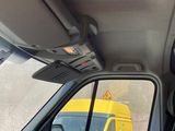 a view of a yellow truck through the rear window of a car