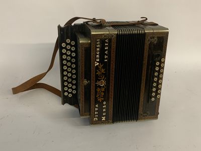 an old accordion sitting on top of a white surface