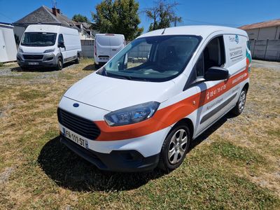 a white van with an orange stripe parked in the grass