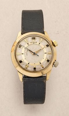 an image of a close up of a wrist watch on a white surface