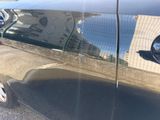 a reflection of a building on the side of a car