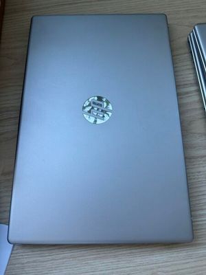 a laptop computer sitting on top of a wooden table