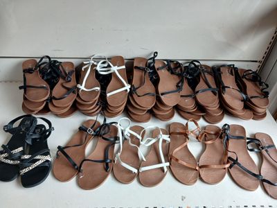 many pairs of sandals that are on a table