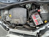 the engine compartment of a car with a car battery in it