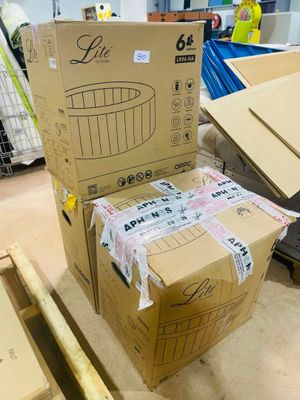 a cardboard box sitting on top of a pallet in a warehouse