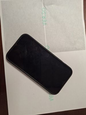 a black cell phone sitting on top of a piece of paper