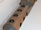 an old gun is sitting on a table with holes in it