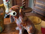 two vases sitting on a table with a dog figurine on it