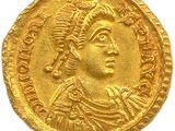 a gold coin with an image of a man wearing a headdress