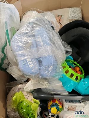 a cardboard box filled with toys and other items