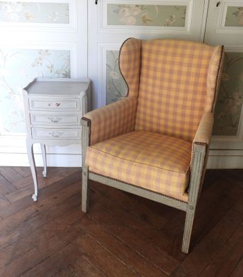une chaise et une table dans une pièce avec du papier peint