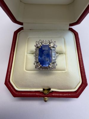 an image of a blue sapphire and diamond ring in a red box