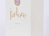 a close up of a box of perfume on a white surface