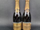 two bottles of champagne sitting on top of a table