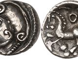 a silver coin with an image of a horse on it