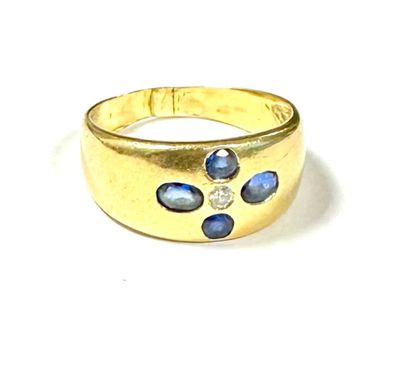 an image of a close up of a gold ring with blue stones