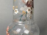 a glass vase with a floral design on it