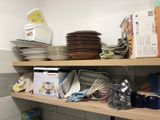 many plates and pans on the shelves in the kitchen