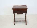 a small wooden table with a drawer on top of it