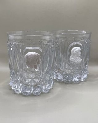 two glasses that are sitting next to each other on a table