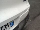 a white car parked in a parking lot next to a fire hydrant