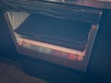 an open oven with a book on top of it