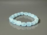 bracelet made of blue glass beads on a reflective surface