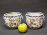 two bowls that are sitting next to a green apple