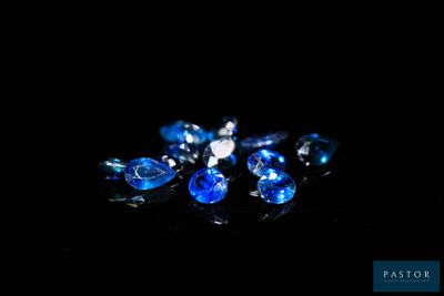 some very pretty blue and white crystals on a black surface