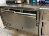 a stainless steel counter with a dishwasher on it
