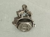 a silver locke with a picture on it on a table