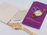 a gold watch and a book on a table