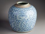 a blue and white vase with a bird on it