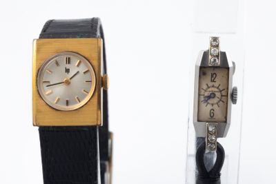 two watches sitting next to each other on a table