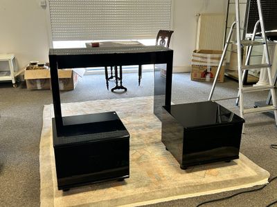 two speakers sitting on a table in the middle of a room