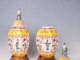 two vases and a small figurine are sitting on a table